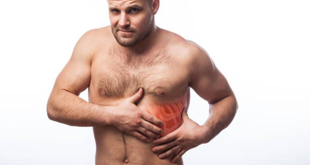 Muscular man clutching his chest with a highlighted rib area, indicating pain from costochondritis.