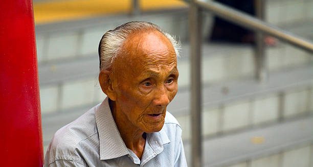 Elderly man sitting with a distant, solemn expression, symbolising cognitive and neurological decline associated with Creutzfeldt-Jakob disease.