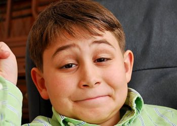 Child with DiGeorge syndrome raising hands