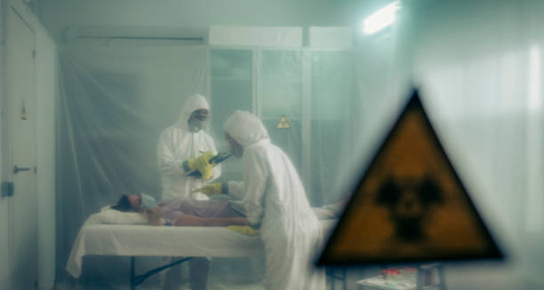 Medical team in hazmat suits treating a patient in quarantine due to Ebola complications.