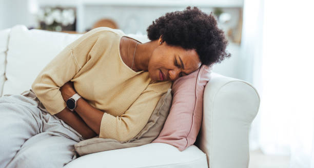 Woman in pain holding abdomen, showing complications of ectopic pregnancy.