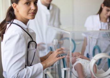 Neonatal doctors attending to a newborn in intensive care for complications of Edwards’ Syndrome.