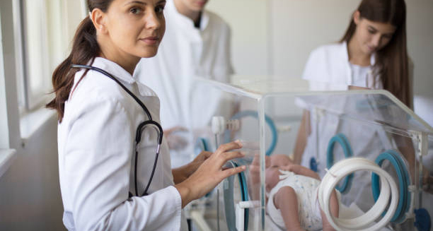 Neonatal doctors attending to a newborn in intensive care for complications of Edwards’ Syndrome.