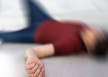 Blurred image of person lying unconscious after a seizure, illustrating epilepsy complications