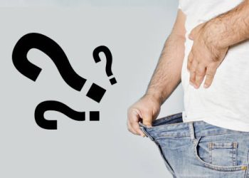 Man looking into his pants with question marks, symbolising complications of erectile dysfunction