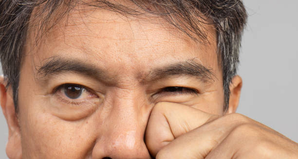 Man experiencing discomfort from eye cancer complications