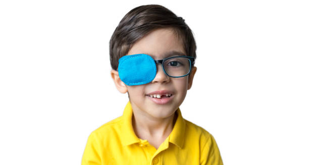 Young boy wearing glasses with an eye patch on one eye