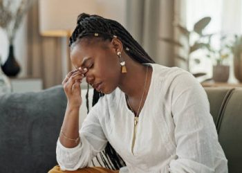 Medical model of female pelvis held by doctor in gloves