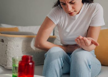 Woman experiencing abdominal pain due to fibroid complications