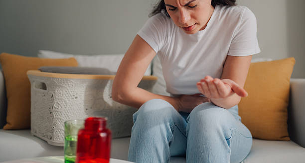 Woman experiencing abdominal pain due to fibroid complications