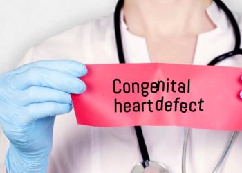 Doctor holding a red card labelled congenital heart defect