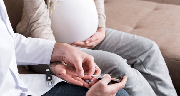 Doctor checking blood sugar of pregnant woman