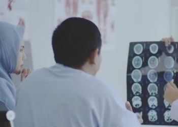 Neurologist reviewing MRI brain scans for Chiari malformation diagnosis