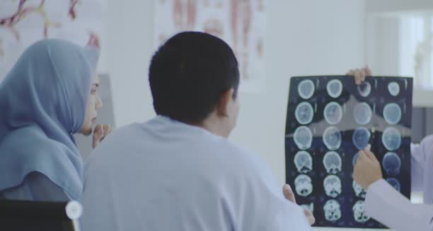 Neurologist reviewing MRI brain scans for Chiari malformation diagnosis
