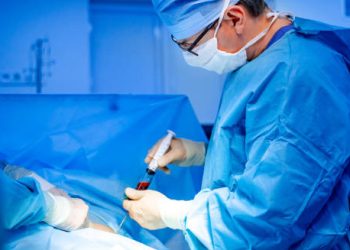 Doctor collecting blood sample in sterile conditions for chronic lymphocytic leukaemia diagnosis