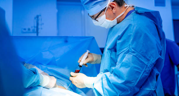 Doctor collecting blood sample in sterile conditions for chronic lymphocytic leukaemia diagnosis