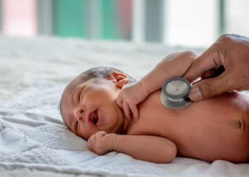 Doctor using a stethoscope to examine a newborn for congenital heart disease