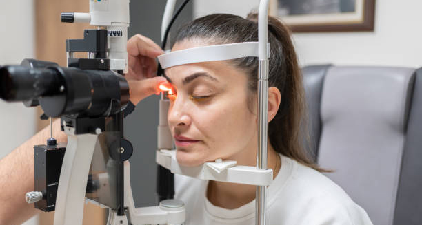 Woman undergoing eye examination for conjunctivitis diagnosis