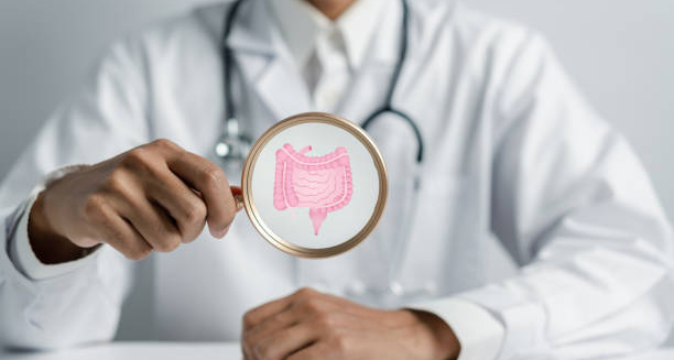 Doctor holding magnifying glass highlighting a graphic of the intestines, illustrating constipation diagnosis.
