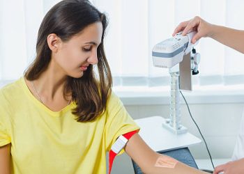 Woman undergoing a medical test on her arm, possibly a skin or blood test, as part of diagnostic procedures for Cushing’s syndrome.