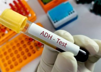 ADH test tube held in gloved hand