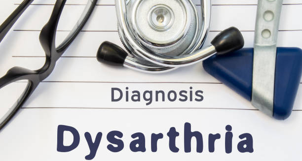 Medical tools and paper with the word Dysarthria written on it