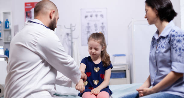 Doctor assessing a young girl for developmental coordination issues