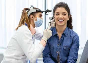 Doctor examining patient’s ear for infection