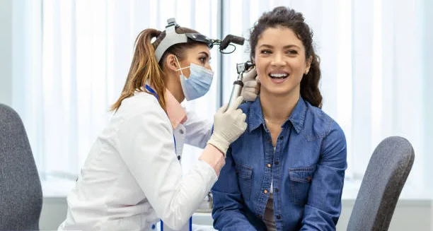 Doctor examining patient’s ear for infection