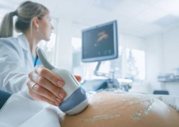 Pregnant woman undergoing ultrasound screening to detect chromosomal abnormalities like Edwards’ Syndrome.