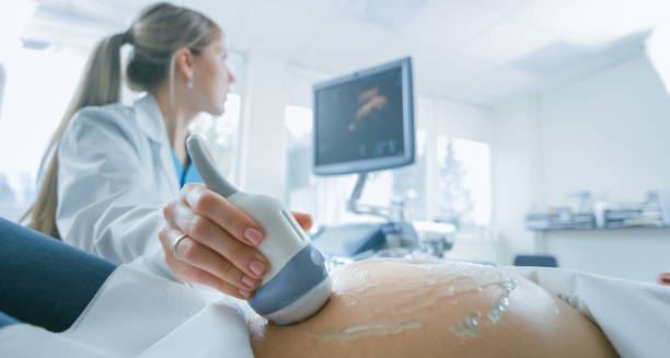 Pregnant woman undergoing ultrasound screening to detect chromosomal abnormalities like Edwards’ Syndrome.