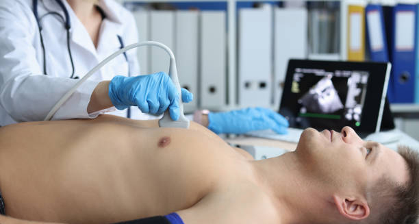 Doctor performing heart ultrasound to diagnose endocarditis in a male patient.