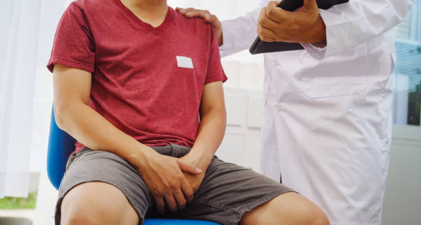 Doctor consulting a man with pelvic discomfort during diagnosis of enlarged prostate