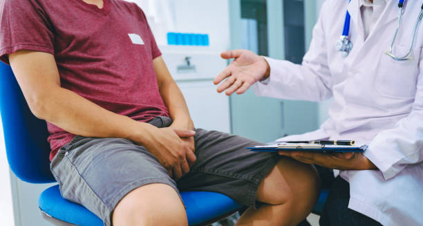 Man consulting with urologist about groin pain, indicating possible epididymitis
