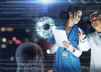 Doctors analysing eye cancer scan using digital imaging technology