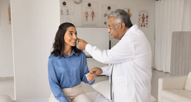 Doctor examining a young woman's eyes