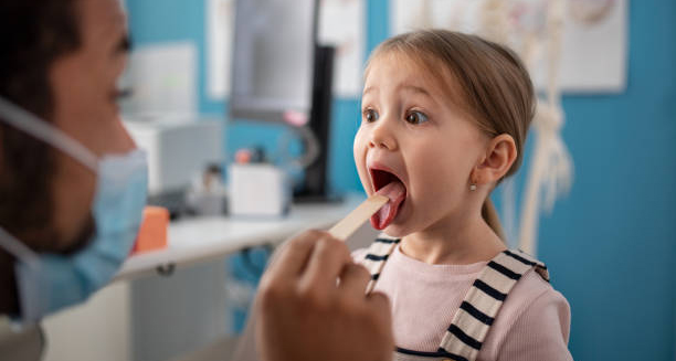 Paediatrician examining young girl for febrile seizure diagnosis