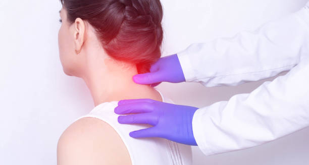 Doctor examining woman's neck for fibromyalgia diagnosis