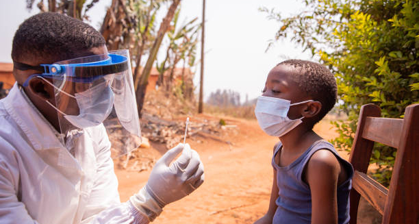 Healthcare worker performing Ebola test on child in outdoor rural setting.