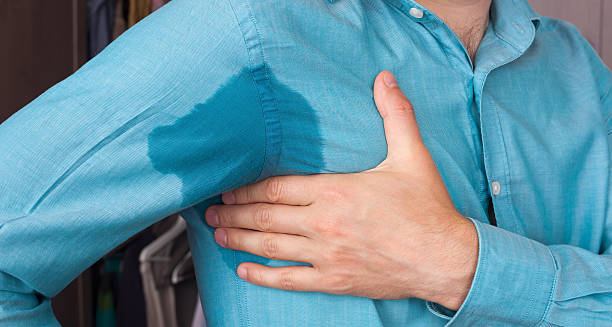 Man with underarm sweat stain experiencing excessive sweating