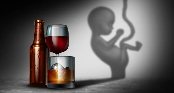 Alcoholic beverages casting a shadow of a fetus representing Fetal Alcohol Spectrum Disorder
