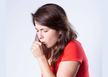 Woman coughing persistently, showing symptoms of chronic obstructive pulmonary disease.