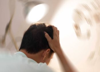 Man experiencing dizziness and confusion, common symptoms of chronic traumatic encephalopathy.