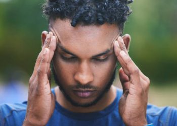 Man experiencing headache and disorientation, symptoms of concussion