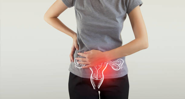 Woman holding her lower abdomen with an illustrated overlay of the bladder and uterus indicating pain.