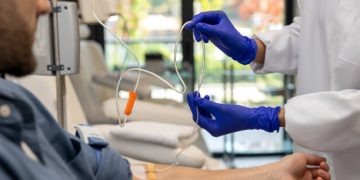 Medical professional administering intravenous treatment for chronic lymphocytic leukaemia