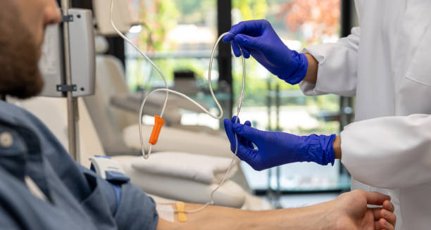 Medical professional administering intravenous treatment for chronic lymphocytic leukaemia