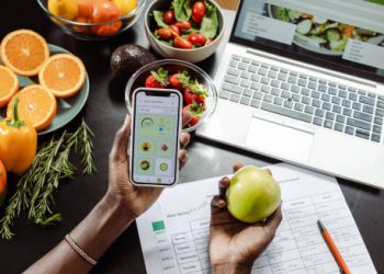 Person using a nutrition tracking app while planning a gluten-free diet