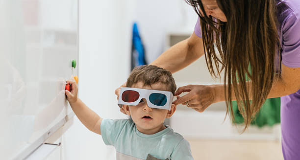 Young child wearing colour correction glasses during vision therapy