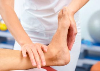 Physiotherapist performing rehabilitation exercises for compartment syndrome